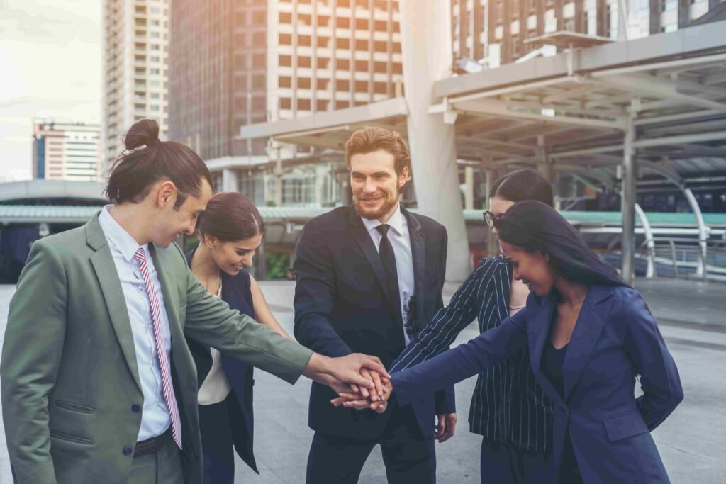 close up business people hands together teamwork